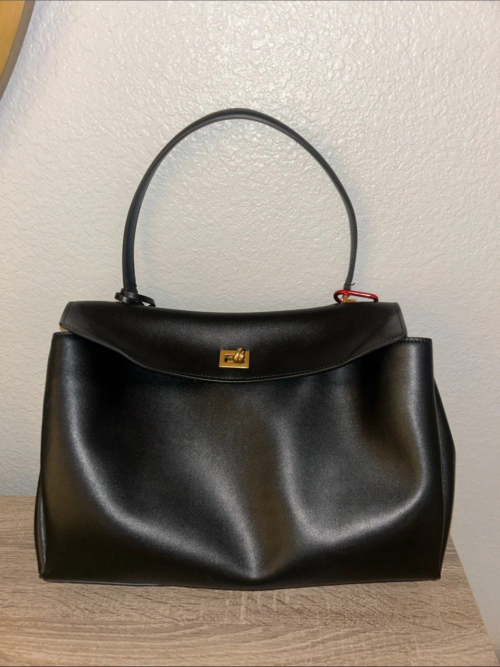 Black Leather Top-Handle Bag with Gold Hardware, keychain and lucky charm